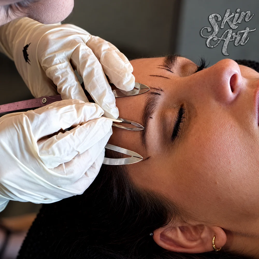 Microblading practitioner working with a client